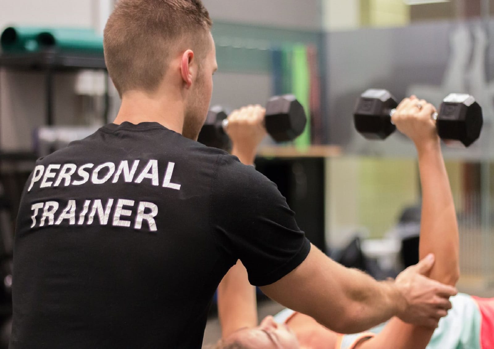 personal trainer works with client
