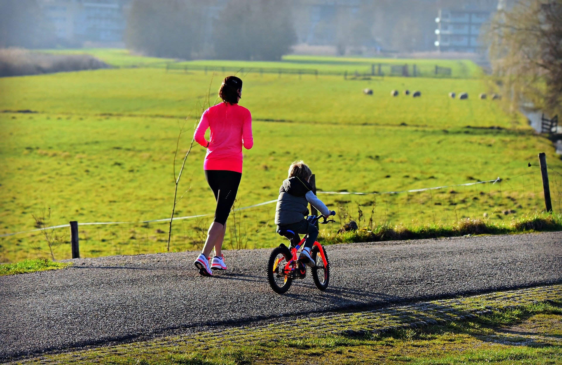 Mum running with child on bike