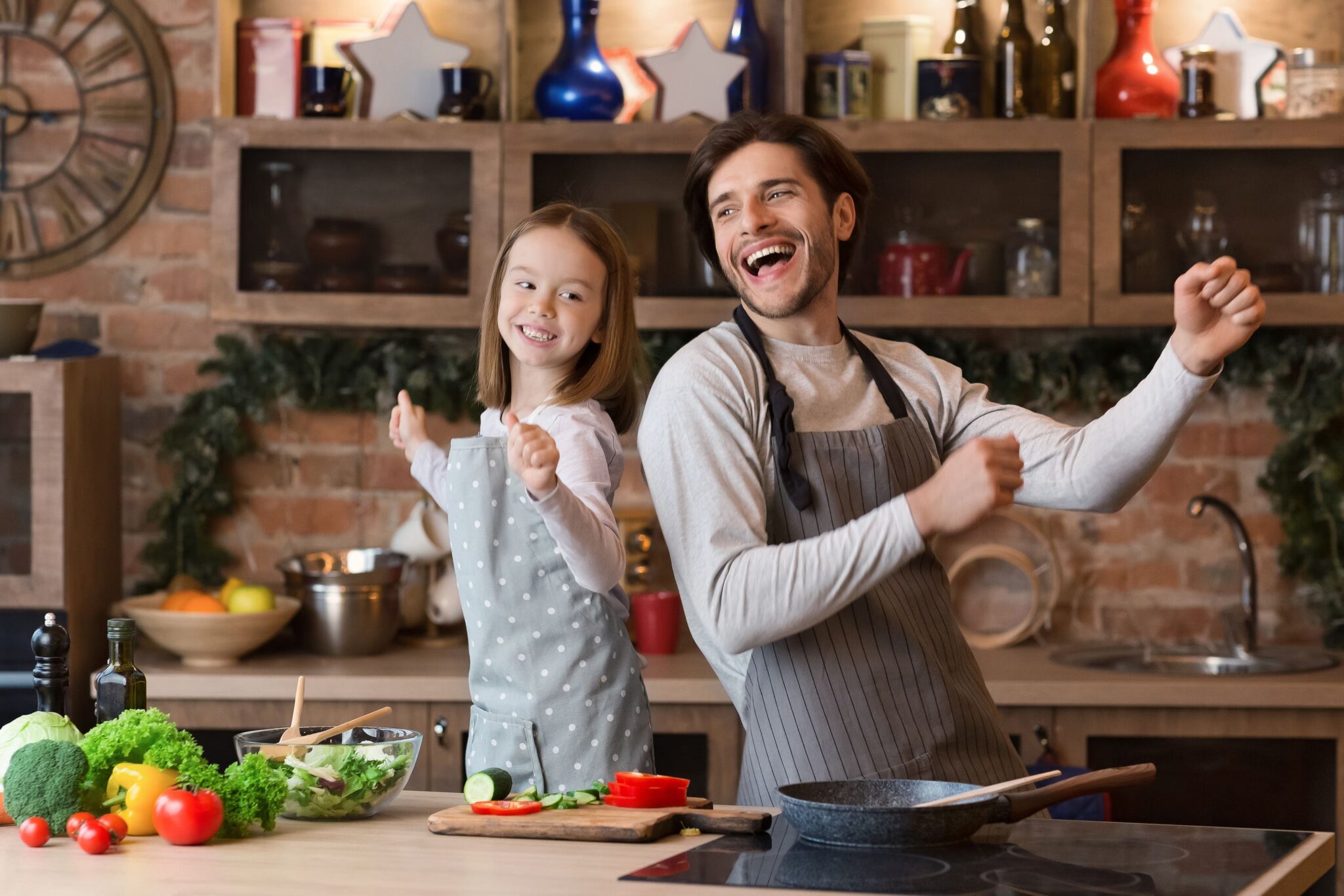 Chef and child dance in kitchen