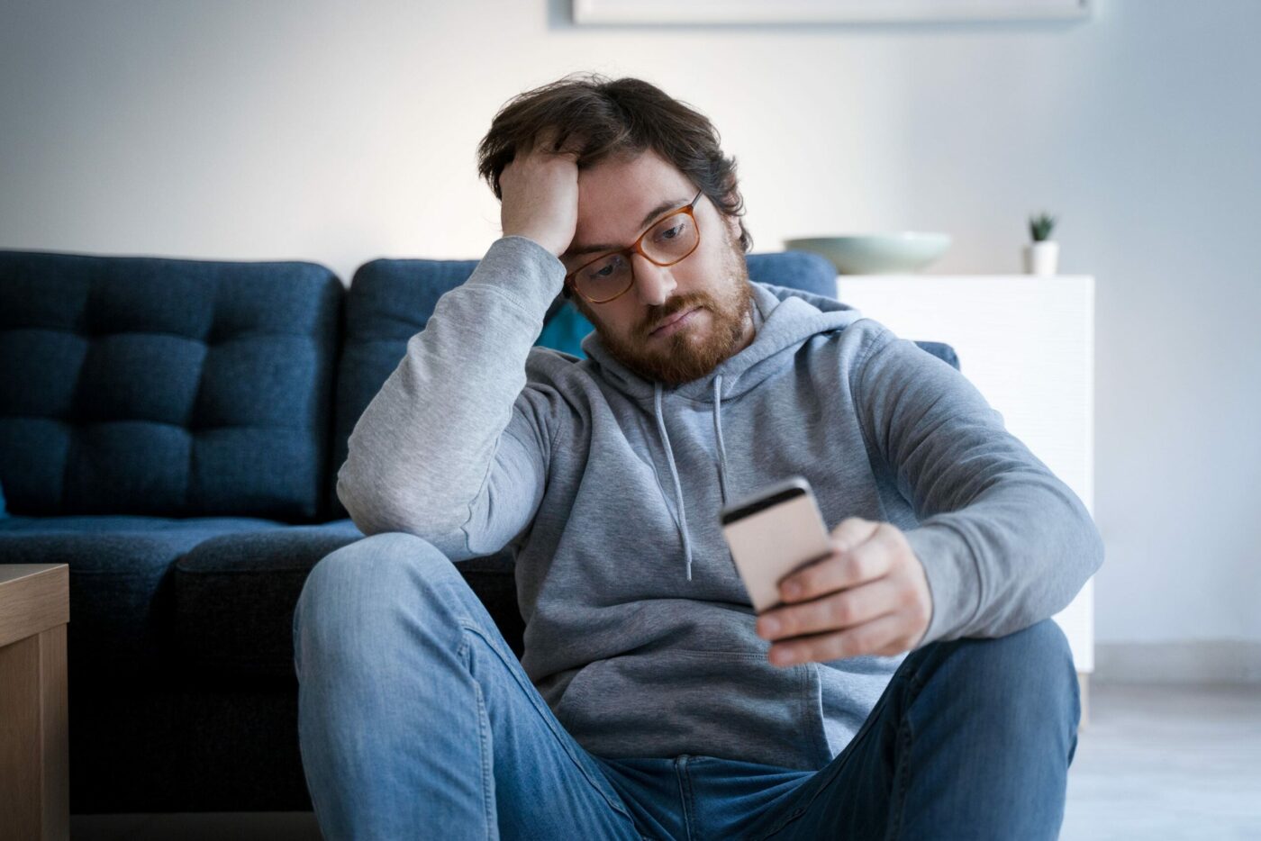 man looks stressed looking at phone scaled e1635092029412