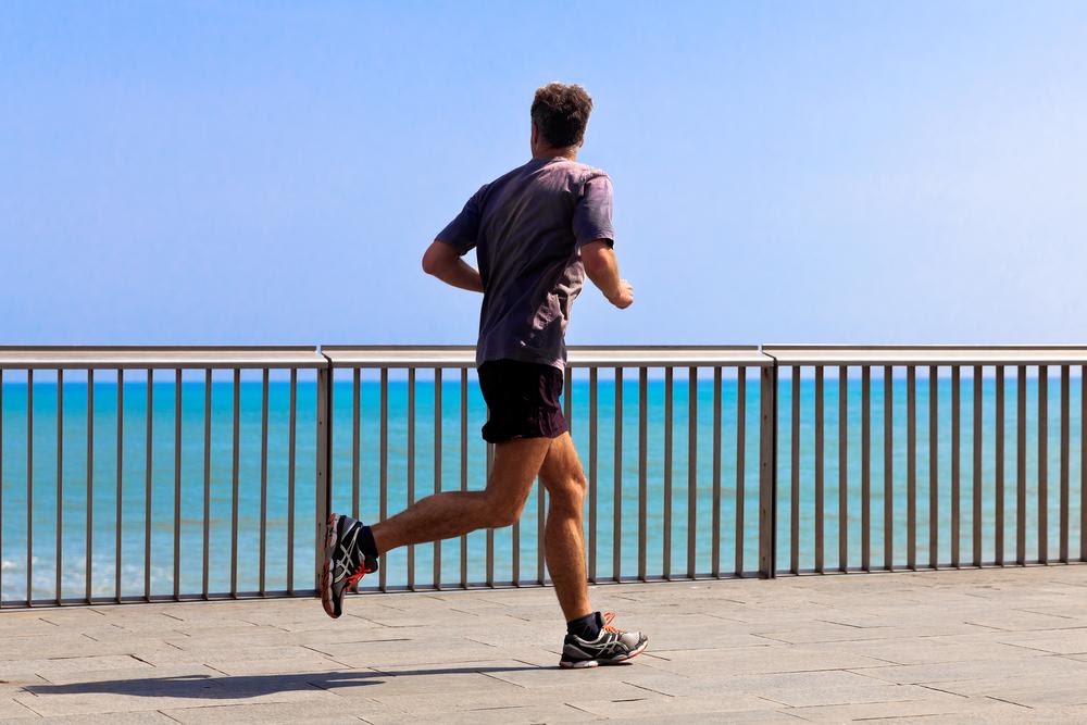runner running looking at the sea