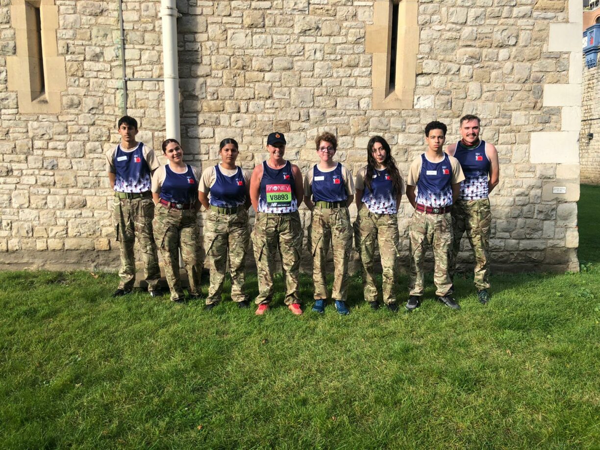 Army cadets national ambassador sally orange and cadets from city of london and north east sector acf starting the tower of london marathon.
