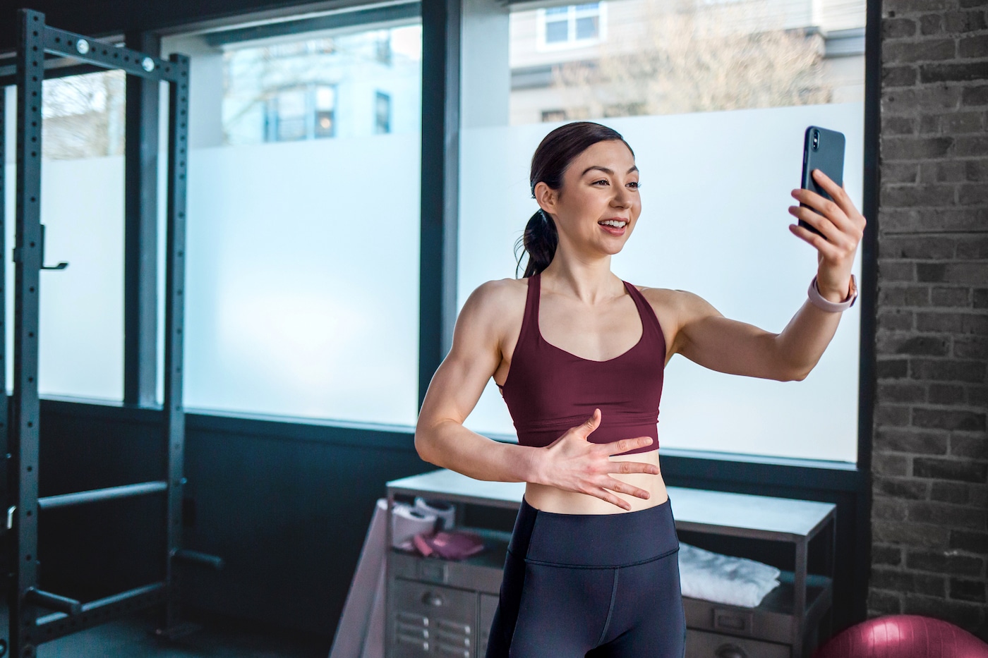 Fitness woman looks at phone