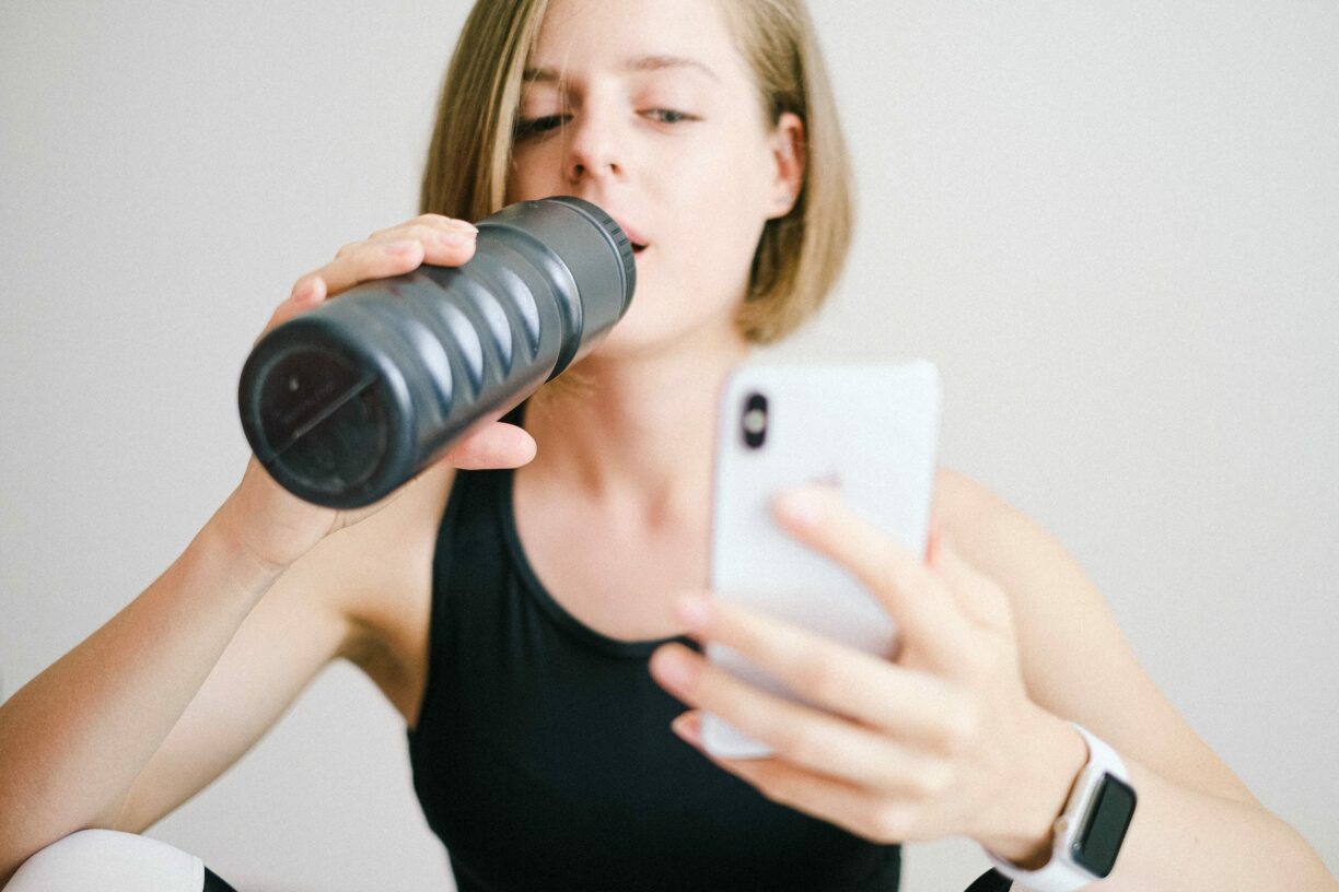 fitness woman checks phone app