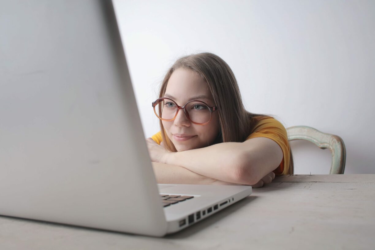 young person swoons over laptop screen