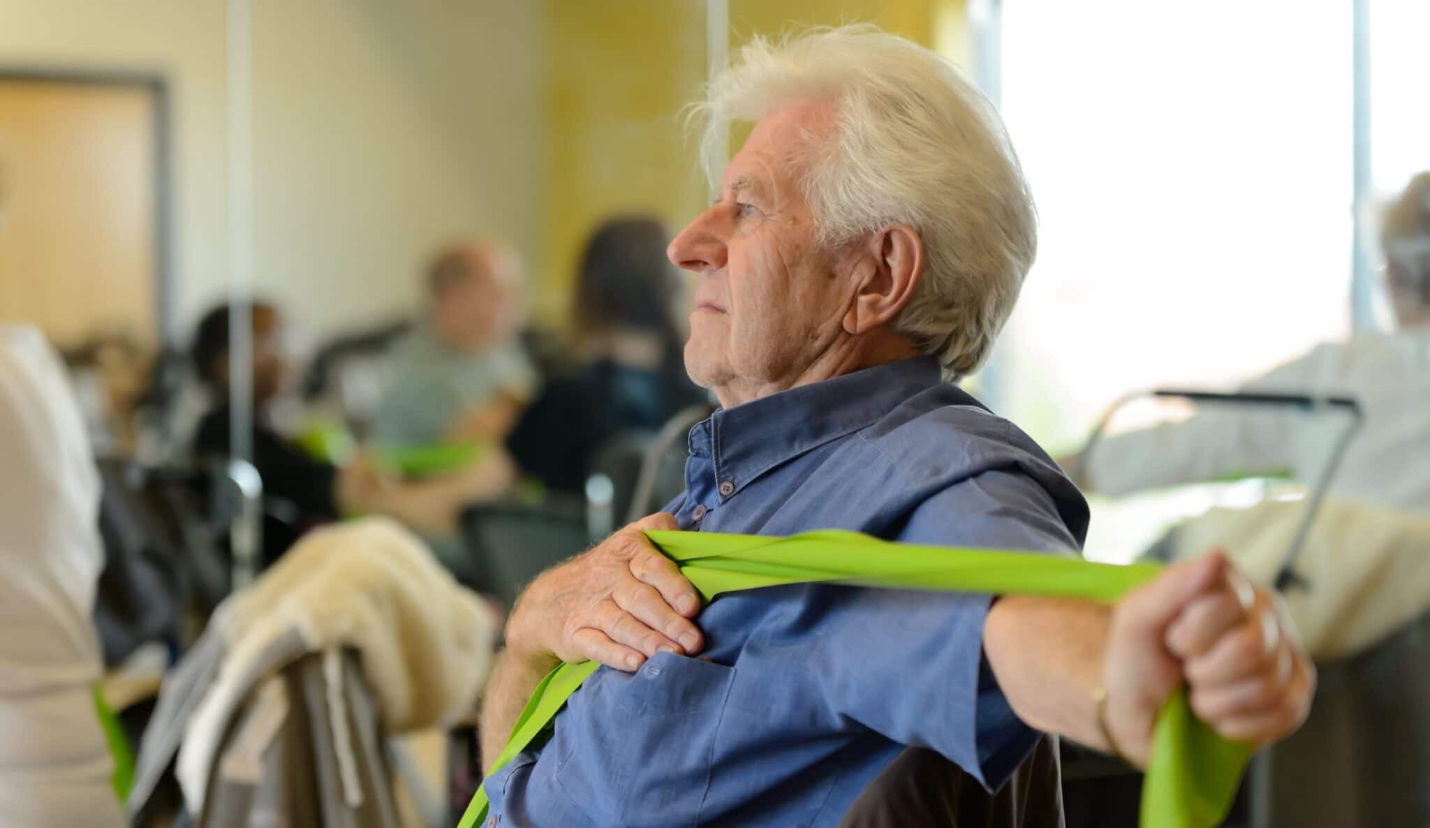 Mature man stretches exercise band