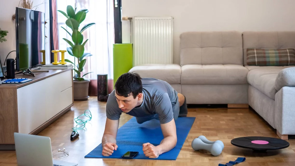 man works out in living room