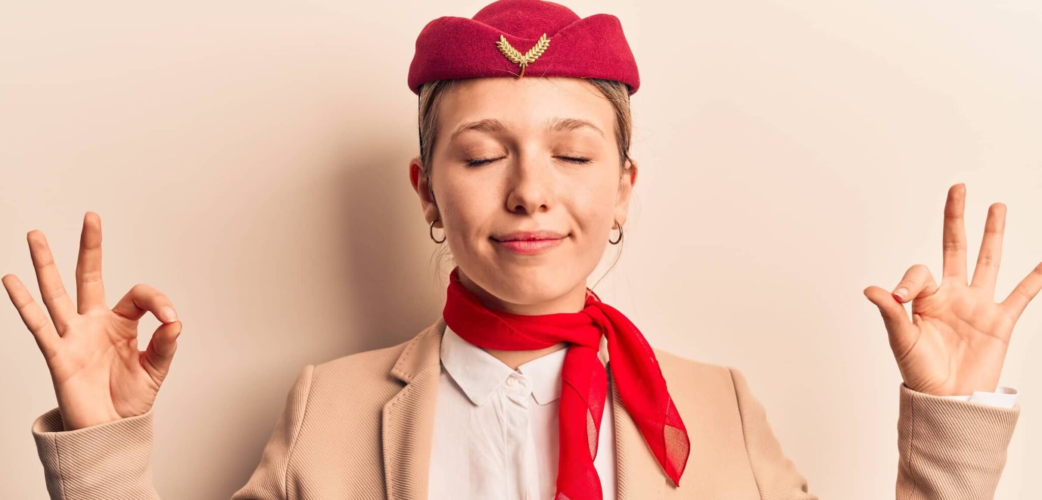 stewardess with eyes closed doing meditation gesture with fingers. yoga concept
