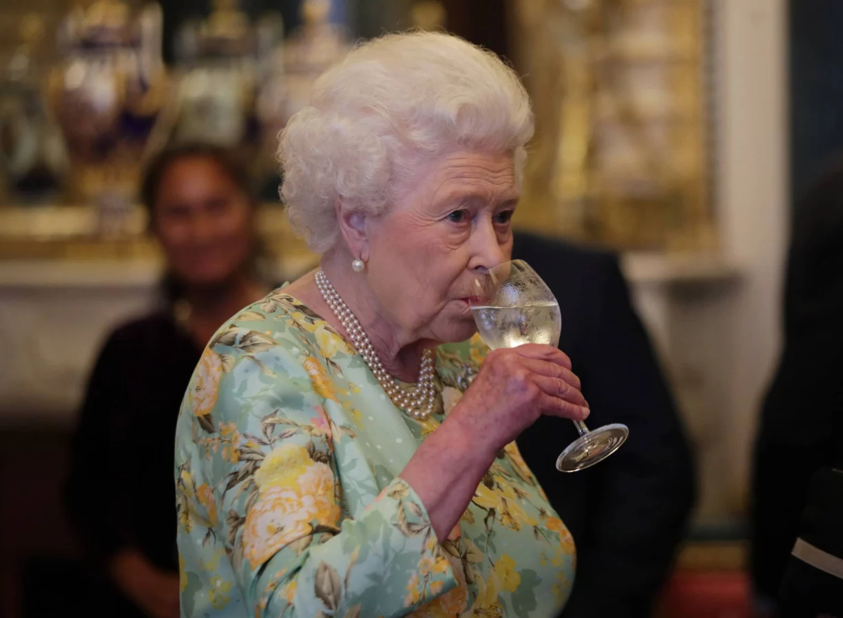 the queen sips wine