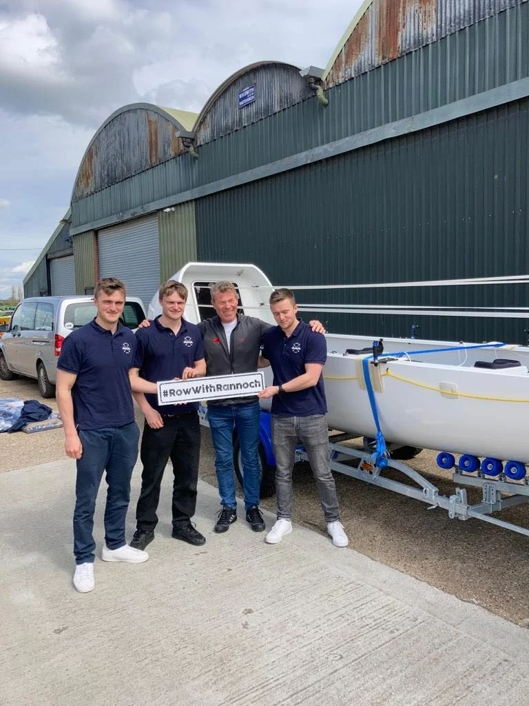 The boys alongside their father Hugo picking up their vessel