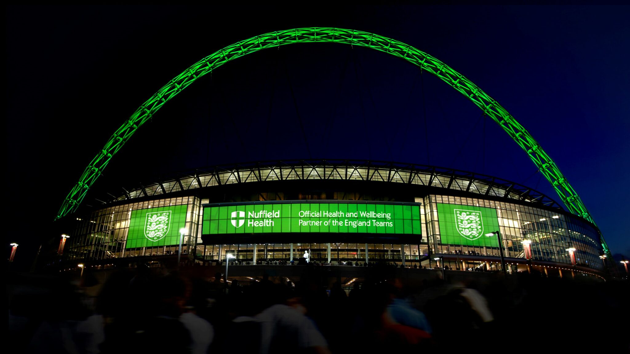 Wembley stadium lit up in nuffield health logo