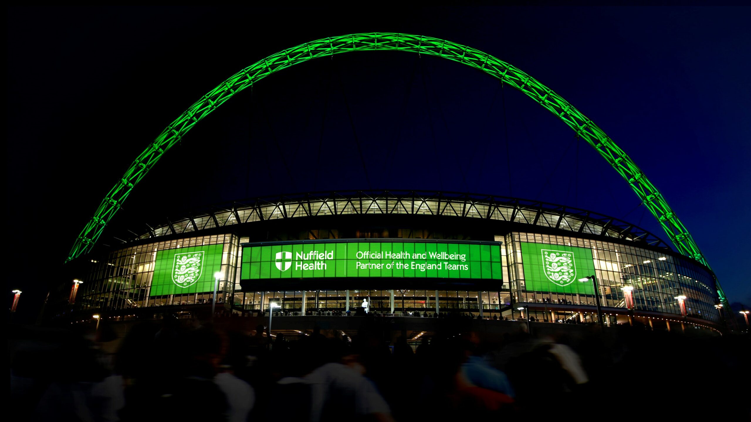 wembley stadium lit up in nuffield health logo scaled