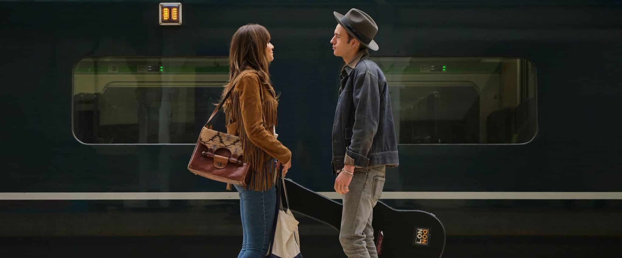couple look at each other on train platform