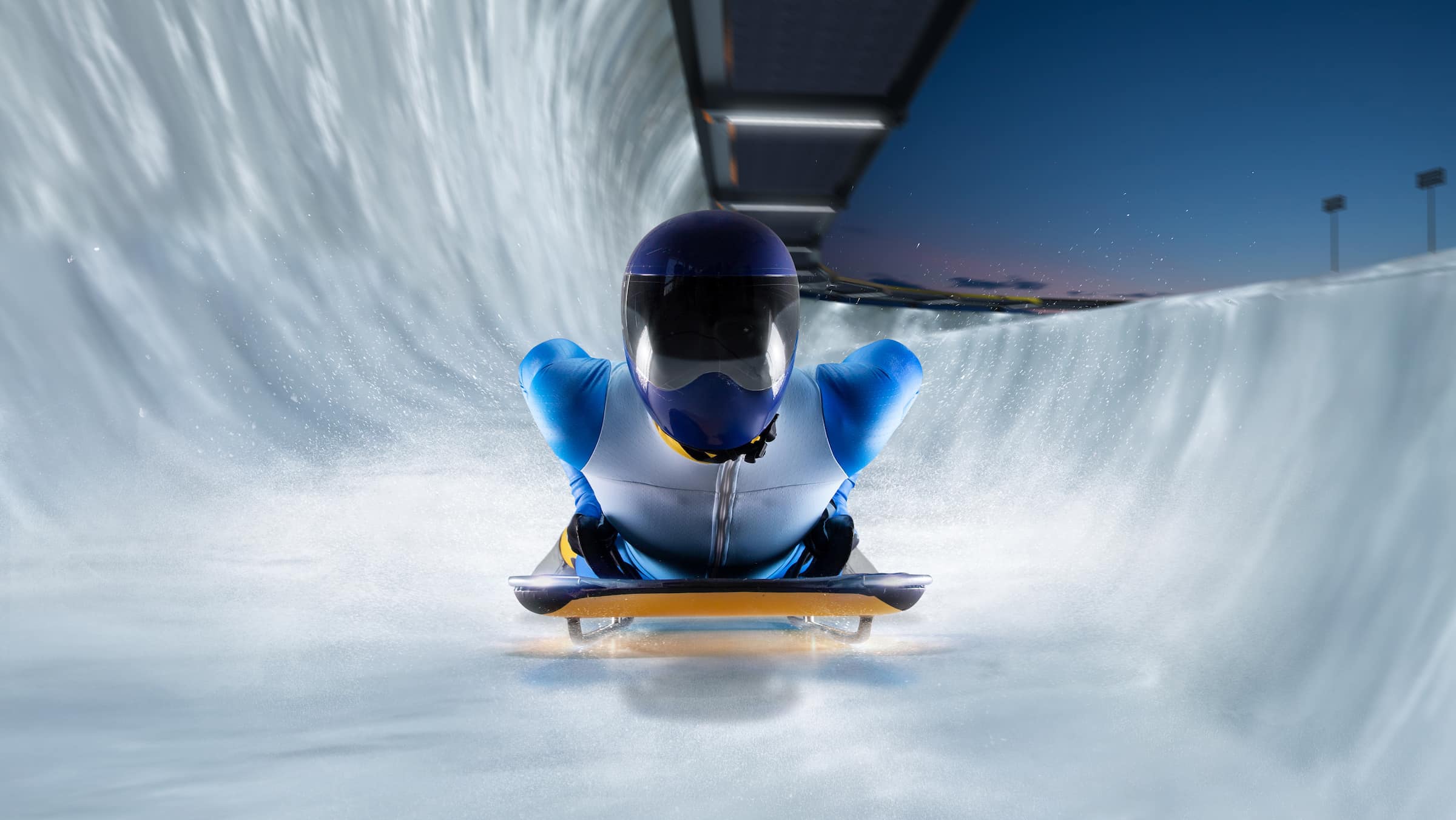 athlete descends on a sleigh on an ice track