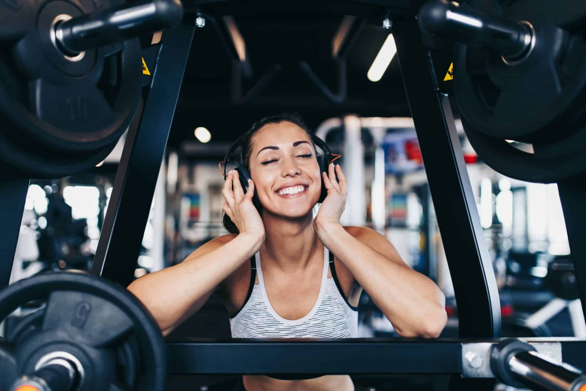 fit woman listens to her music in the gym